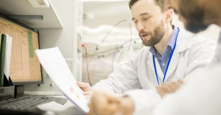 Confident lab engineer explaining information to colleague