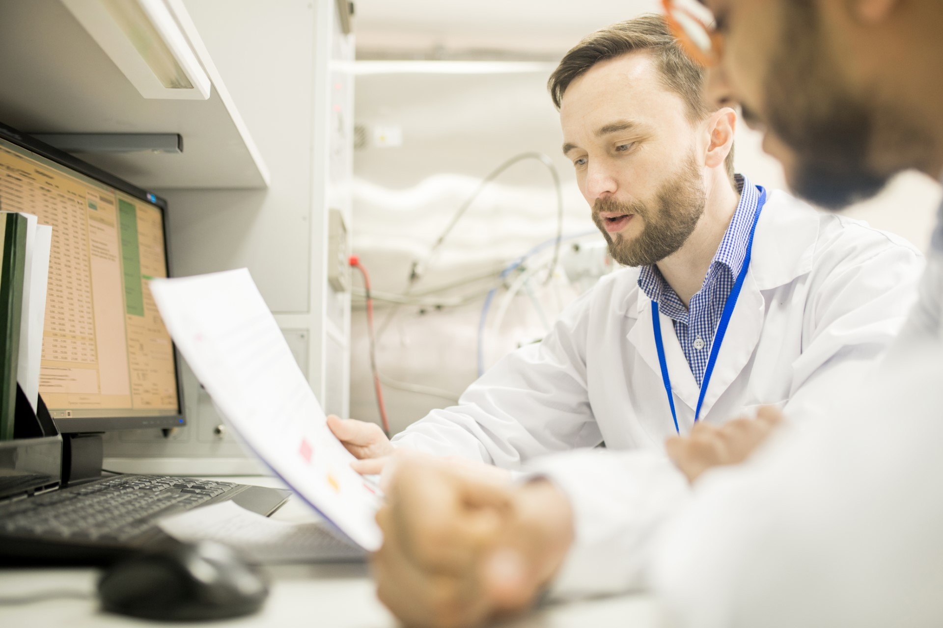 Confident lab engineer explaining information to colleague